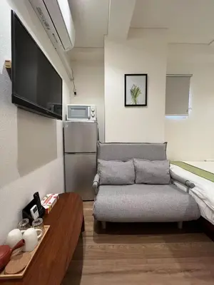 a small living room with a couch and a table at dandelion house in Tokyo
