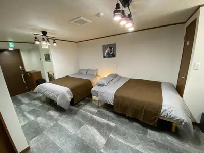 a bedroom with two beds and a mirror at ONE HOUSE SHINKOIWA - Vacation STAY 26055v in Tokyo