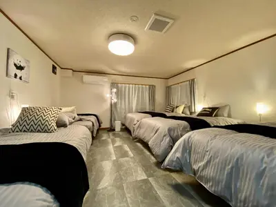 a room with four beds in it with lights at ONE HOUSE SHINKOIWA - Vacation STAY 26055v in Tokyo