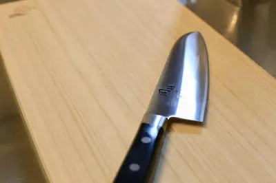 a knife sitting on top of a wooden cutting board at \u3077\u3075\u304b\u4e80\u6238 in Tokyo