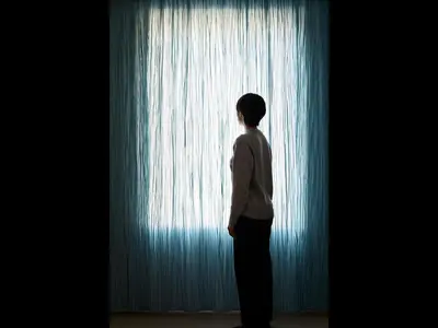 a person standing in front of a window at 9h nine hours Ningyocho in Tokyo