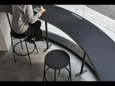 a person sitting on a stool at a table at 9h nine hours Ningyocho in Tokyo
