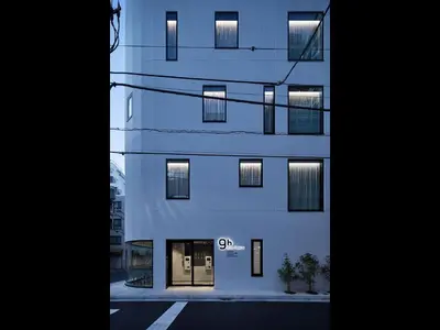 a tall building with its windows lit up at night at 9h nine hours Ningyocho in Tokyo
