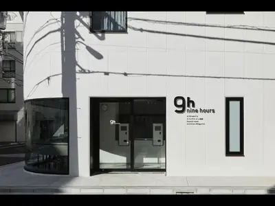 a white building with the door open on a street at 9h nine hours Ningyocho in Tokyo