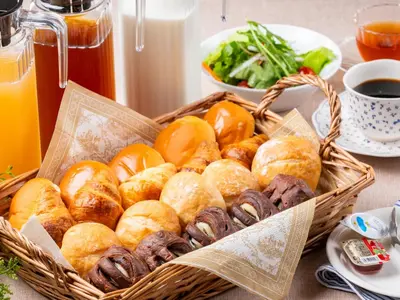 a basket of bread and croissants on a table at APA Hotel Shimbashi Toranomon in Tokyo