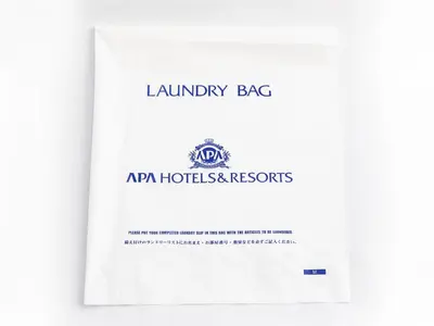 a catalogue of the laundry agency of australia with a white document at APA Hotel Shimbashi Toranomon in Tokyo