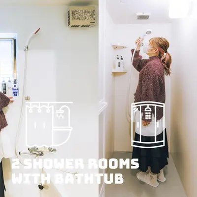 a woman standing in a bathroom with a shower room at LovesunshineBackpackers in Tokyo