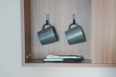 a cabinet with two pots and pans hanging from it at ICHIYU HOTEL ASAKUSA in Tokyo