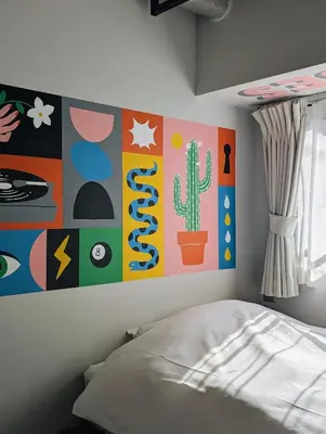 a bedroom with a cactus painting on the wall at ART HOTELS SHIBUYA in Tokyo