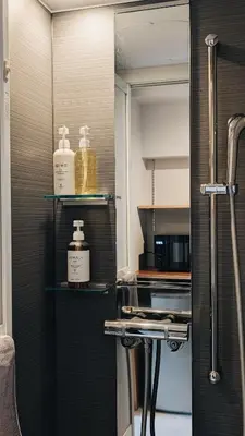 a small kitchen with two bottles ofagents on shelves at ART HOTELS SHIBUYA in Tokyo
