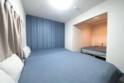 a small room with a bed and a window at NY Cottage A in Tokyo