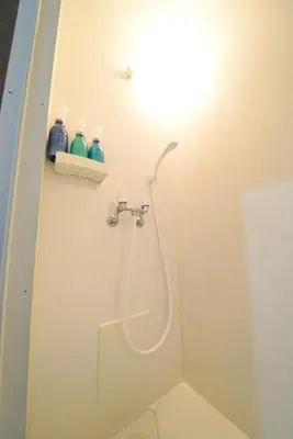 a shower with a hose in a bathroom at NY Cottage A in Tokyo