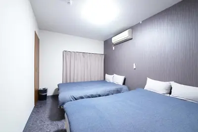 a hotel room with two beds and a window at NY Cottage A in Tokyo
