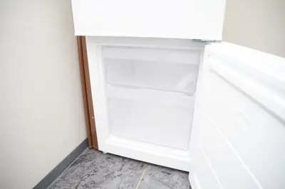 an open refrigerator door in a room at NY Cottage B in Tokyo
