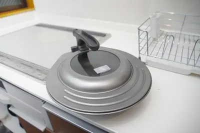 a stack of plates sitting on top of a dishwasher at NY Cottage B in Tokyo