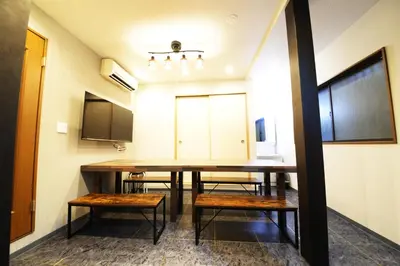a dining room with a table and benches at NY Cottage B in Tokyo