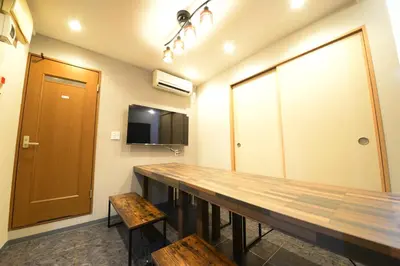 a conference room with a wooden table and benches at NY Cottage B in Tokyo