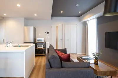 a living room with a couch and a table at Ken's Place麻布East in Tokyo