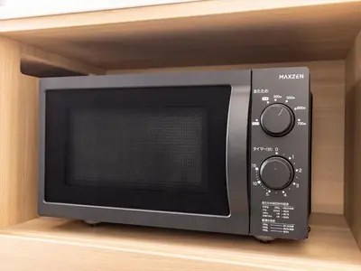 a microwave oven sitting on a shelf in a cabinet at Tokyu Stay Shimbashi - Ginza area in Tokyo