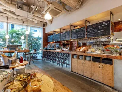 a restaurant with a counter with a lot of food at Tokyu Stay Shimbashi - Ginza area in Tokyo