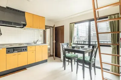 a kitchen with a table and chairs in a kitchen at PAPA301 in Tokyo