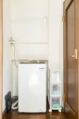 a white refrigerator in a room with an open door at PAPA301 in Tokyo