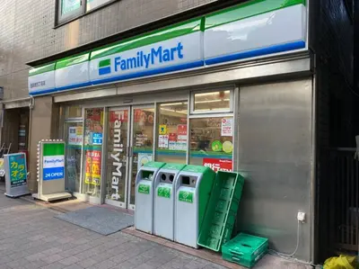 a familymart store front with fourrecylling machines in front at PAPA301 in Tokyo