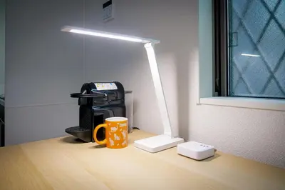 a desk with a coffee mug and a lamp on it at Triphome Tateishi New open/2 single beds/big table/300M WiFi in Tokyo