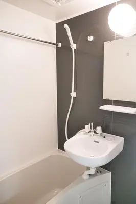 a bathroom with a white sink and a mirror at Triphome Tateishi New open/2 single beds/big table/300M WiFi in Tokyo