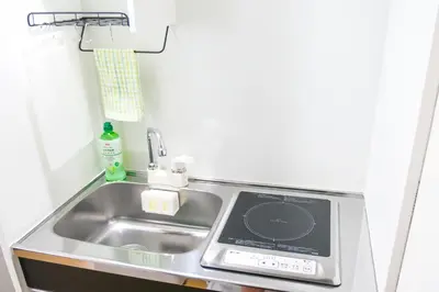a kitchen sink with a scale next to it at Triphome Tateishi New open/2 single beds/big table/300M WiFi in Tokyo