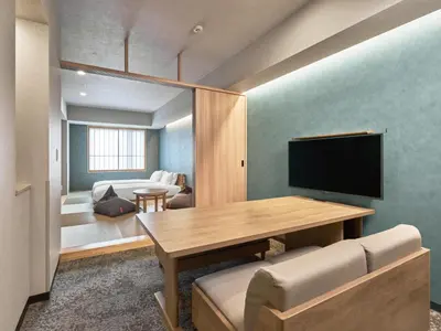 a living room with a table and a television at MIMARU Tokyo Ikebukuro in Tokyo