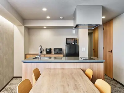 a kitchen with a wooden table and a sink at MIMARU Tokyo Ikebukuro in Tokyo