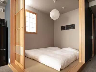 a bed in a room with a large mirror at MIMARU SUITES Tokyo Asakusa in Tokyo