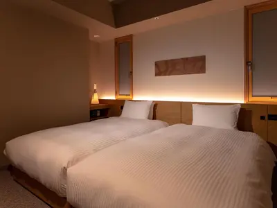 a bedroom with two beds with white sheets at MIMARU SUITES Tokyo Asakusa in Tokyo