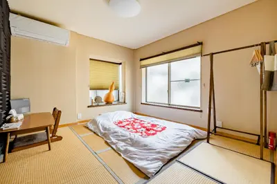 a bedroom with a bed and a desk and a window at Dat's house in Tokyo