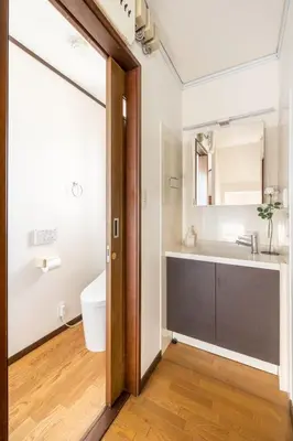 a bathroom with a sink and a mirror at Dat's house in Tokyo