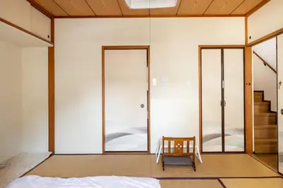 a room with two glass doors and a chair at Dat's house in Tokyo
