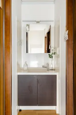 a bathroom with a sink and a mirror at Dat's house in Tokyo