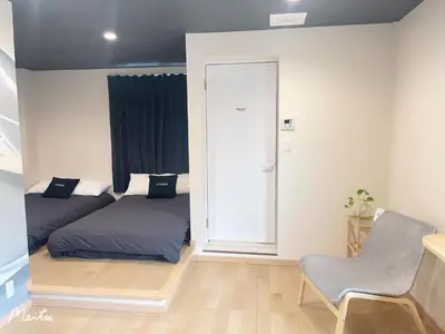 a bedroom with a bed and a chair in it at Leisure hotel \u4e2d\u91ce in Tokyo