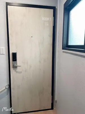 a door in a room with a window at Leisure hotel \u4e2d\u91ce in Tokyo