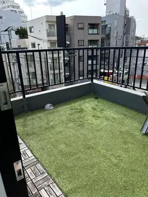 a balcony with green grass on top of a building at Leisure hotel \u4e2d\u91ce in Tokyo