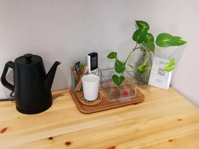 a desk with a tea kettle and a plant on it at Leisure hotel \u4e2d\u91ce in Tokyo