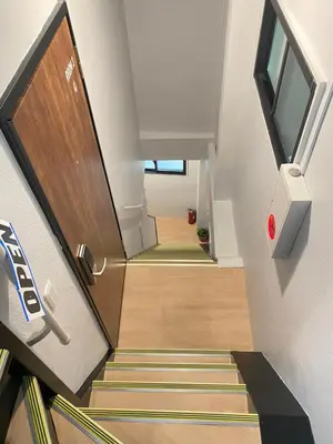 a stairway with a wooden door and a stairwell with a stair at Leisure hotel \u4e2d\u91ce in Tokyo