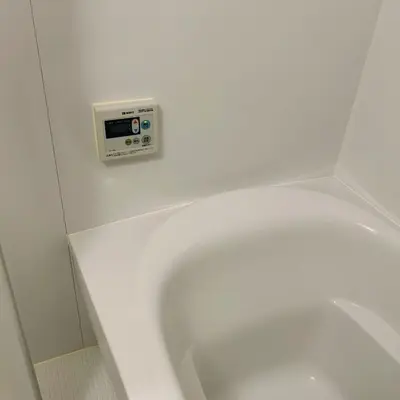 a bathroom with a white toilet with a clock on the wall at AYA Hotel in Tokyo