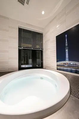a large bath tub in a bathroom with the eiffel tower at La Krasse Skytree - Vacation STAY 12839 in Tokyo
