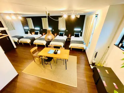 a living room with two beds and a table at \u30db\u30c6\u30eb\u30af\u30e9\u30c3\u30b7\u30fc\u30b9\u30ab\u30a4\u30c4\u30ea\u30fc\u6d45\u8349\u66f3\u821f in Tokyo