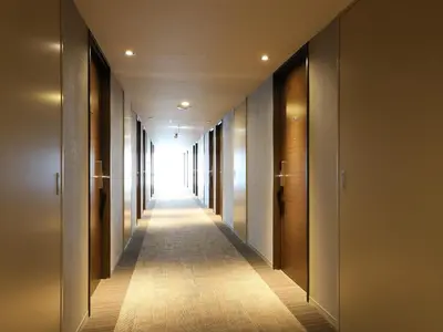 a hallway of a building with a long corridor at Smile Hotel Shinagawa Sengakuji Ekimae in Tokyo