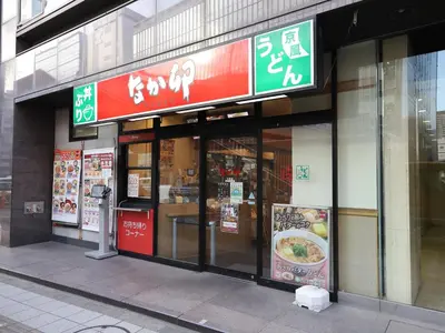 a store with signs on the side of a building at Smile Hotel Shinagawa Sengakuji Ekimae in Tokyo