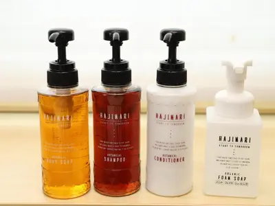 four bottles of hair products sitting on a shelf at Smile Hotel Shinagawa Sengakuji Ekimae in Tokyo