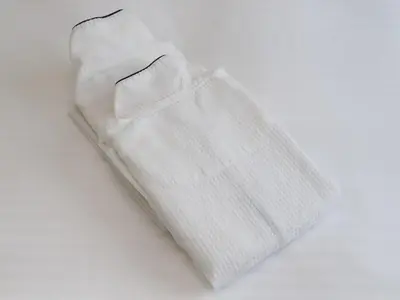 a pair of white socks on a white background at Smile Hotel Shinagawa Sengakuji Ekimae in Tokyo